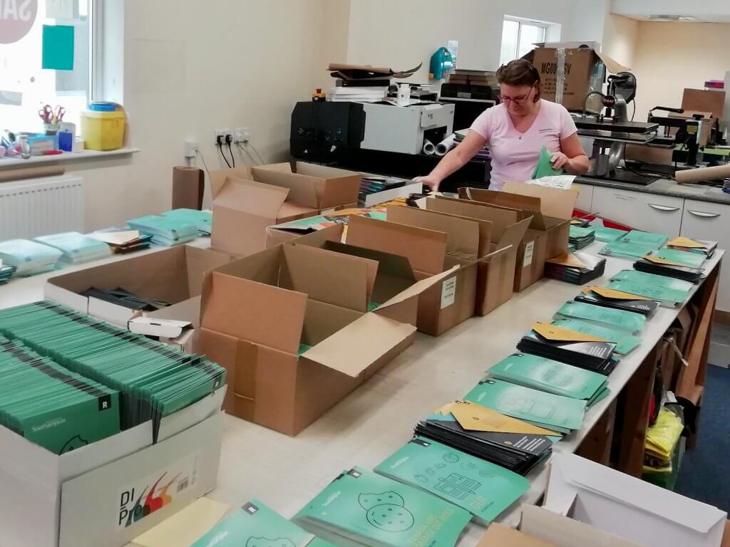 A worker packing up the activity packs