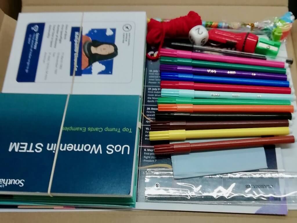 Image of an activity pack with pens, paper, worksheets, and goodies